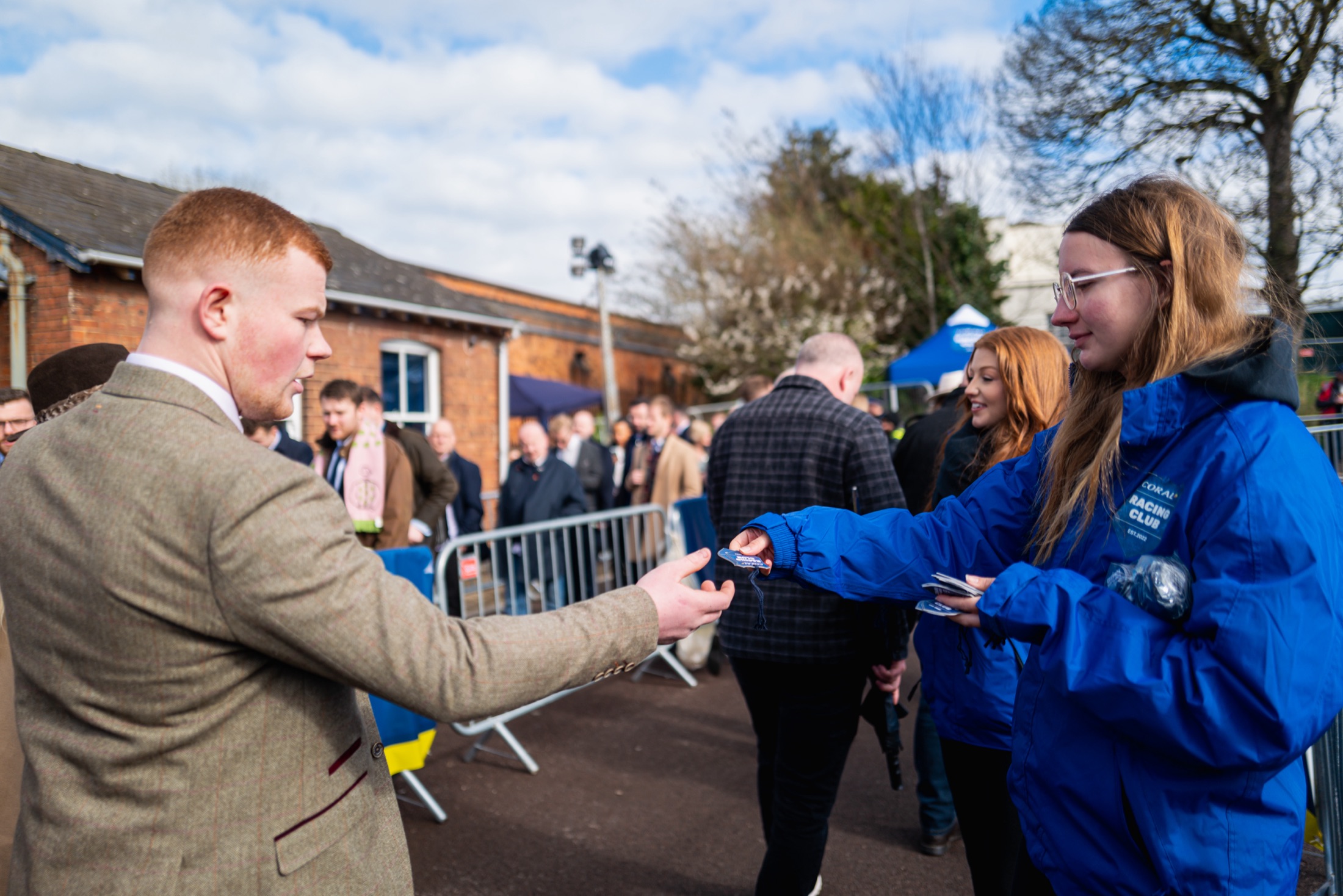 Coral ambassadors handing out exclusive badges to racegoers