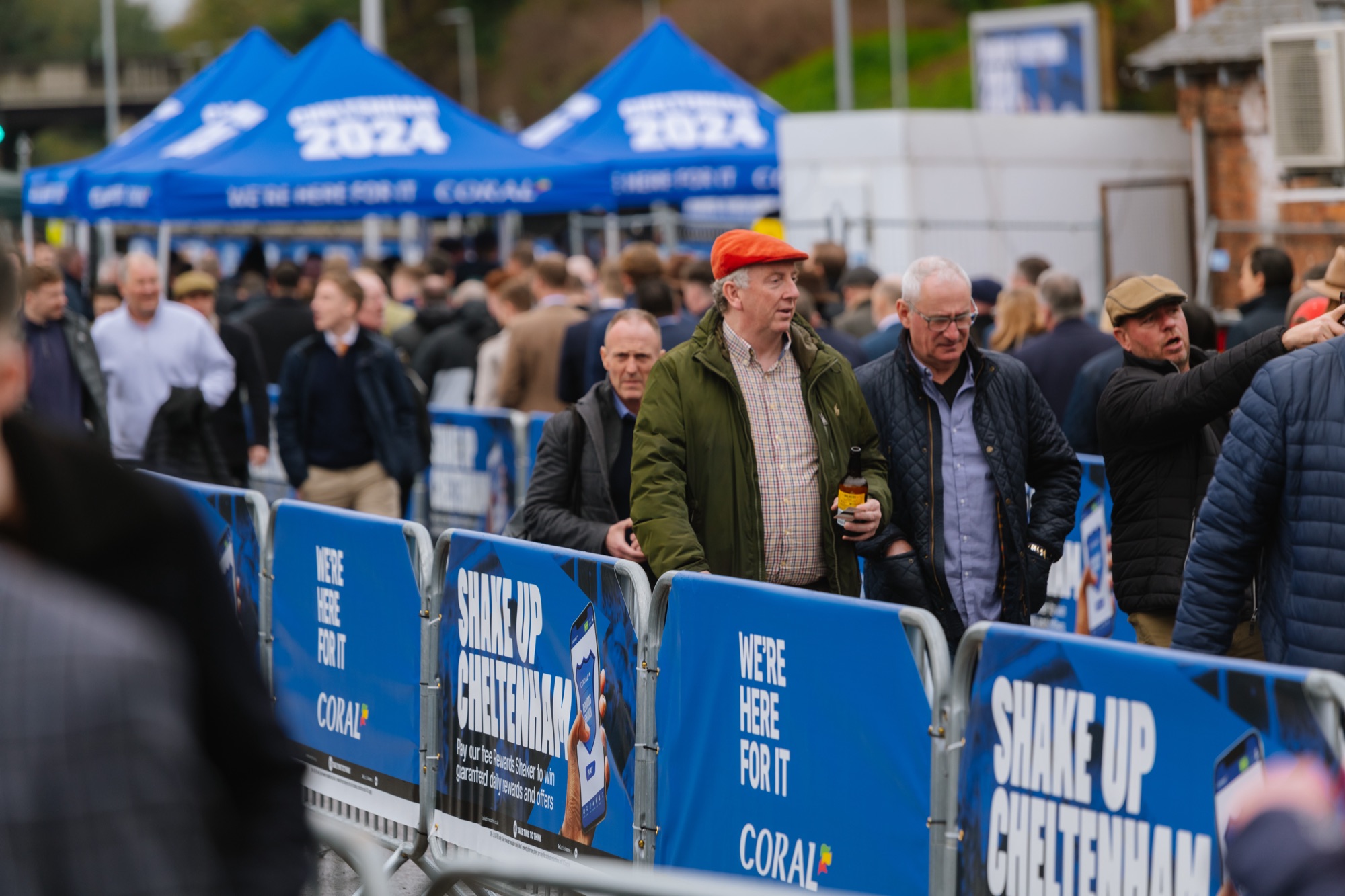 Racegoers passing the Shake up Cheltenham barriers