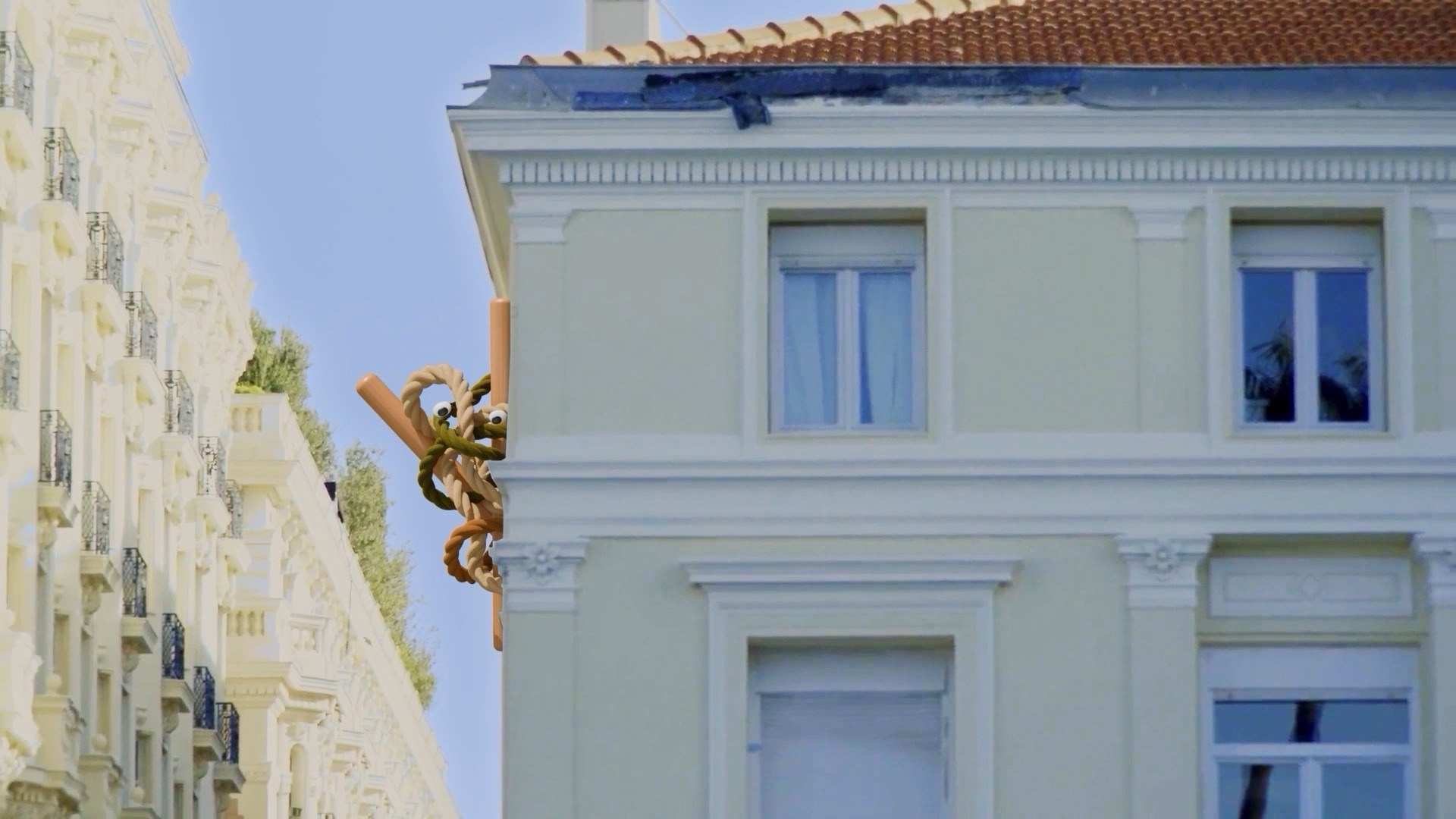 A Creative Demon climbing a Cannes building